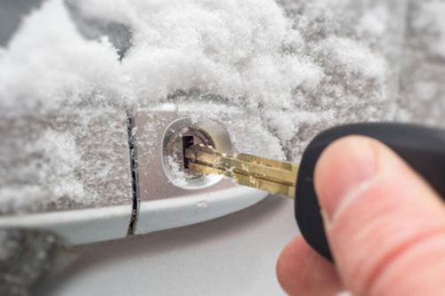 A frozen door lock covered in ice